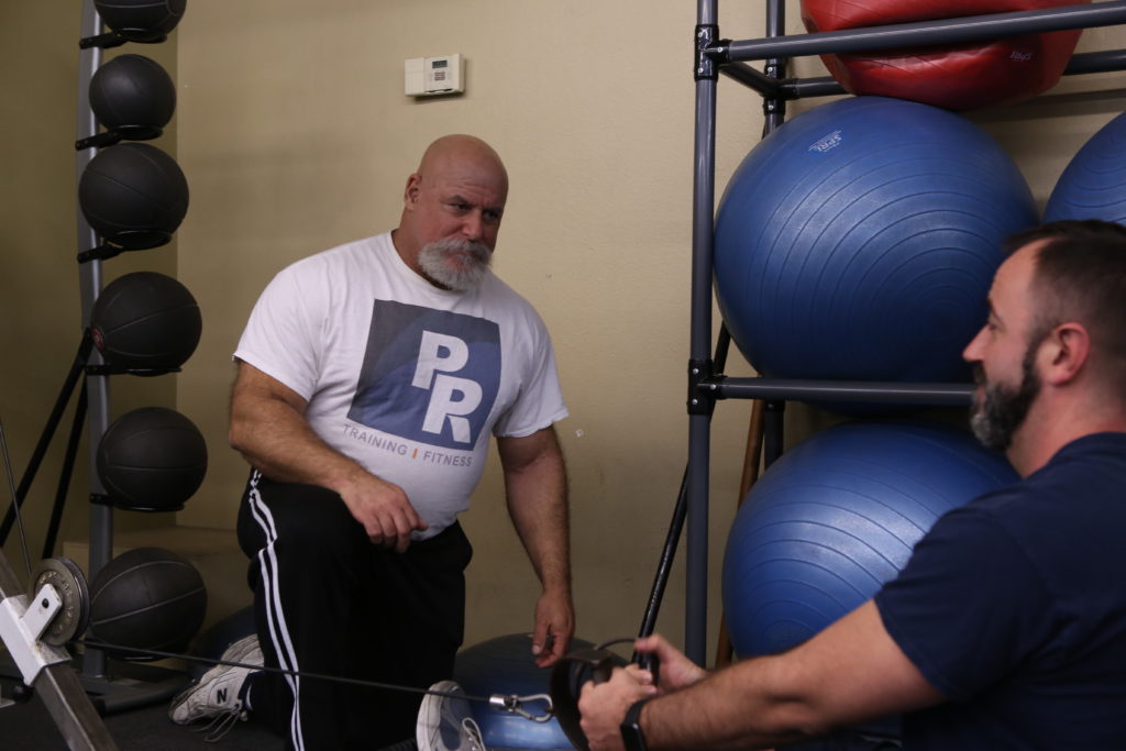 Fitness trainer Phil Rubin working with client, gain muscle, lose weight. Healthy body.